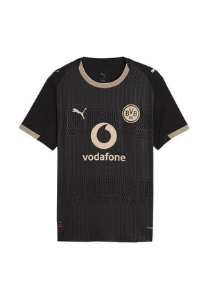 Maillot de football noir avec logo Vodafone beige, logo Puma, emblème BVB 09, motifs géométriques, et bordures beiges sur les manches et le col.