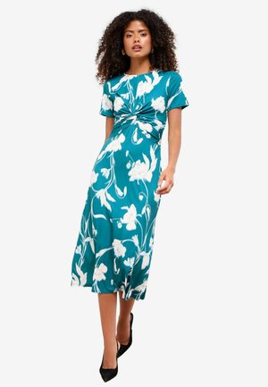 Teele Kleid mit floralem weißen Muster, kurzen Ärmeln und knotenförmigem Taillendesign. Weicher, glatter Stoff und eine lockere, mittel-lange Silhouette.