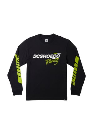Black long-sleeve t-shirt with "DCSHOECO Racing" logo in white and neon green. Features graphic patterns on sleeves and ribbed cuffs.