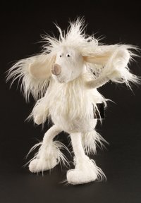 White plush toy with shaggy fur, round head, large floppy ears, and a small brown snout. Stands on two feet, arms raised. Black tag visible.