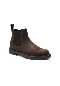 Botas Chelsea de cuero marrón con paneles laterales elásticos, punta redondeada y tirador. Suela texturizada para mayor agarre. Acabado suave con un ligero brillo.