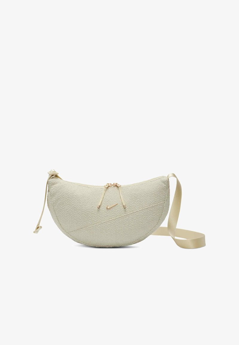 Borsa a tracolla beige con texture, di forma curvata, con zip dorate, piccolo logo Nike dorato e tracolla in tessuto regolabile.