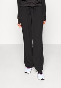 Puma MODEST ACTIVEWEAR WIDE LEG - Treniņtērpa apakšdaļas - black