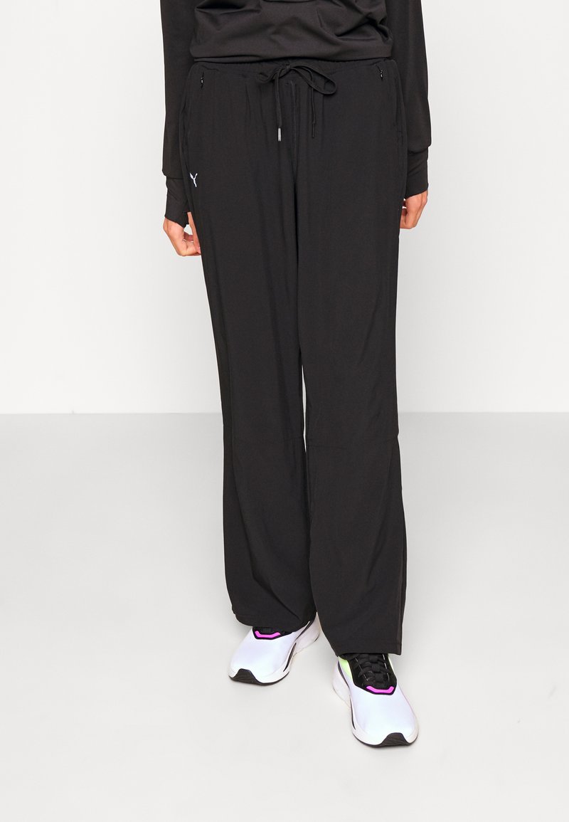 Puma MODEST ACTIVEWEAR WIDE LEG - Treniņtērpa apakšdaļas - black