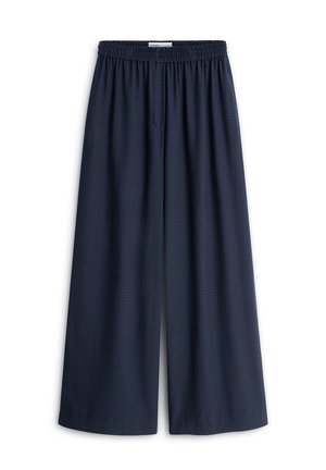Granatowe spodnie z szerokimi nogawkami, elastycznym pasem, fakturowaną tkaniną i luźnym krojem, pokazane na białym tle.