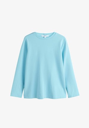 Világoskék, hosszú ujjú póló puha pamutból, környakkivágással és laza fazonnal, finom varrással a szegély mentén.