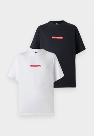 Two T-shirts, one white and one black, both featuring a red Quiksilver logo on the front, in a relaxed fit with short sleeves.