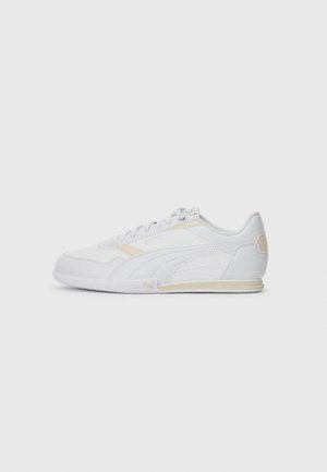 White athletic shoes with a smooth synthetic upper, subtle yellow accents, textured rubber sole, and traditional lace-up design.