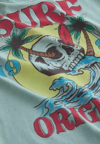 Next Triko s potiskem - blue skull