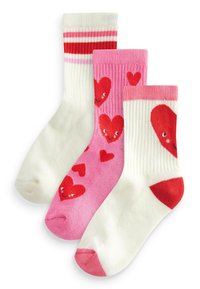 Drei Paar Socken: ein weißes Paar mit roten Streifen, ein pinkes Paar mit roten Herzen und ein weißes Paar mit einem großen roten Herzmotiv. Strickstruktur, bis zur Mitte der Wade.