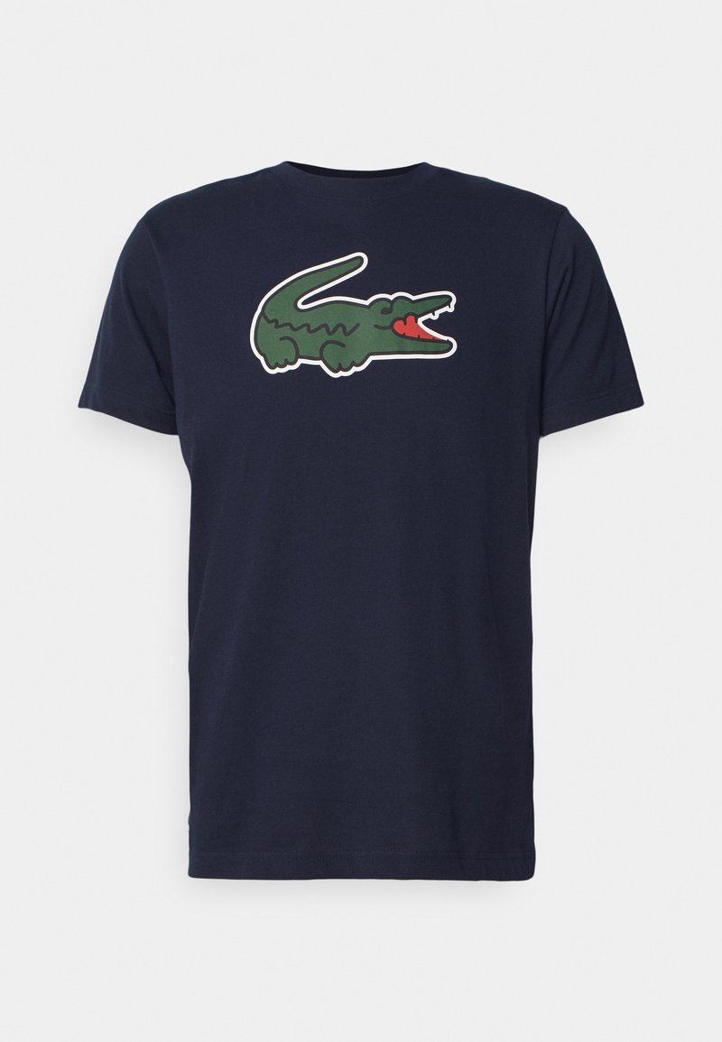 T-shirt in cotone blu navy con un grande logo di coccodrillo verde e la lingua rossa. Collo a giro classico e maniche corte.