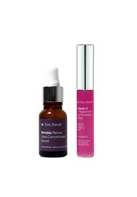 Bursztynowa szklana butelka z białą pipetą do serum; fioletowa etykieta. Błyszcząca z przezroczystą rurką i metalową zakrętką; jasnoróżowy płyn wewnątrz.