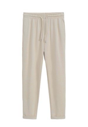 Pantalons de survêtement beiges avec taille élastique et cordon de serrage réglable. Texture lisse avec jambes fuselées et ourlets resserrés.