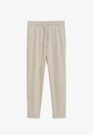 Pantalons de survêtement beiges avec taille élastique et cordon de serrage réglable. Texture lisse avec jambes fuselées et ourlets resserrés.