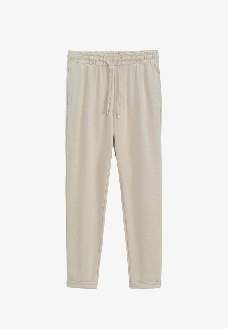 Pantalons de survêtement beiges avec taille élastique et cordon de serrage réglable. Texture lisse avec jambes fuselées et ourlets resserrés.