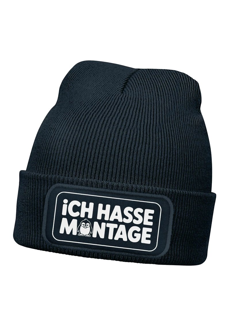 Black knitted beanie with a folded cuff, featuring a rectangular patch with white text "¡CH HASSE MONTAGE!" and a cartoon penguin illustration.