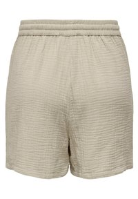 Beige shorts made of textured fabric with an elastic waistband. Features a slightly wrinkled surface and a relaxed fit, hemmed at the bottom.