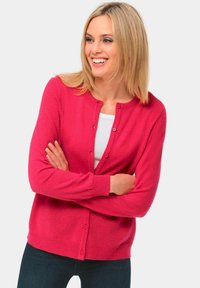 Fuchsia vest met ronde hals, lange mouwen en een sluiting met knopen aan de voorkant. Gemaakt van een zachte, textuurstof, met geribbelde manchetten en zoom.