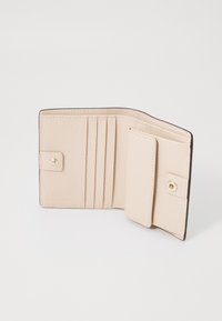 Beige leather wallet with multiple card slots, a snap button closure, textured surface, and dark edge accenting.
