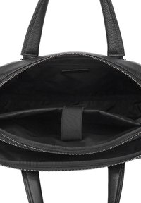 Black leather tote bag with textured surface, interior zip pocket, and fabric lining. Features dual handles and a zip closure.