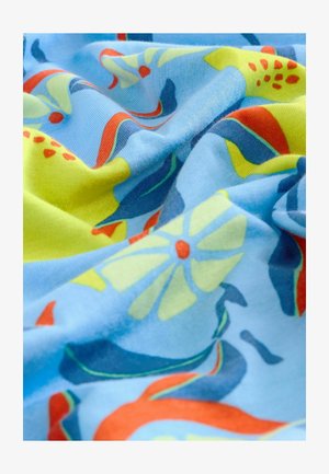 Multicolored fabric featuring a blue background with floral and abstract patterns in green, red, and yellow, showcasing a smooth texture.