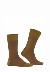 Brązowe skarpetki w prążki z kontrastującym gładkim palcem i piętą. Średnia wysokość, miękka tekstura oraz wzmocnione szwy dla trwałości.