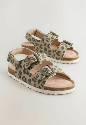 Sandali con stampa leopardata, dotati di due cinghie regolabili, fibbie in metallo e una suola in sughero testurizzato su una base in gomma bianca.
