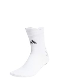 Calcetín blanco hasta el tobillo con el logo negro de Adidas en el cuff acanalado y puntos antideslizantes grises en el talón y la suela.