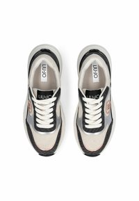 Baskets noires, grises et écrues avec dessus en mesh et synthétique, bout arrondi, lacets blancs et emblème de la marque sur le côté. Semelle plate.