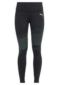 Leggings neri realizzati con un tessuto liscio e elastico. Presentano dettagli turchesi, pattern a pois di dimensioni variabili e una vita alta.