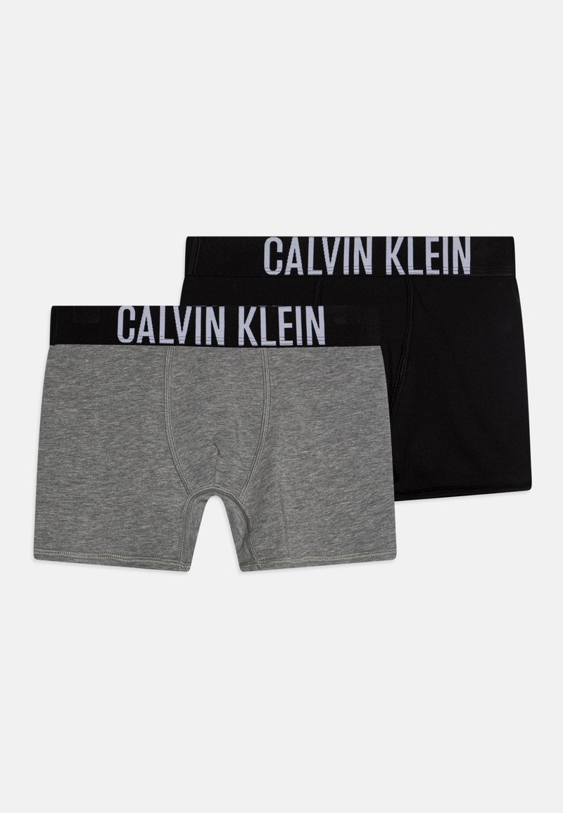 Grijze en zwarte boxershorts met een brede zwarte tailleband waarop "CALVIN KLEIN" in witte letters is gedrukt. Gemaakt van zachte, rekbare stof.
