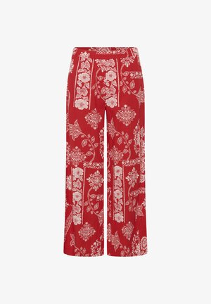 Pantalones anchos rojos con estampados florales y geométricos blancos, con cintura elástica y corte relajado.