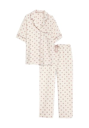 Bomullspyjamas-set som har en kortärmad topp och långa byxor. Ljusrosa bakgrund med ett blommönster och kontrasterande detaljer.