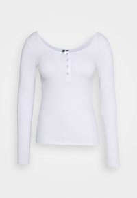 Camisola branca de mangas longas com textura canelada, decote largo e três botões de pressão na frente. Feita de um tecido macio e elástico.