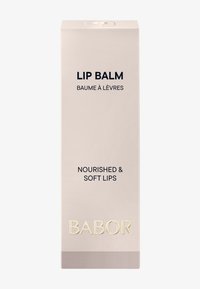 Lippenbalsam-Verpackung in sanftem Beige, mit fettem schwarzen Text und goldenem Logo. Die Schachtel hat eine rechteckige Form und eine glatte Textur.