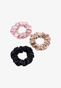 Three satin scrunchies: one pale pink, one champagne gold, and one black. All have a smooth texture and gathered design with elastic.