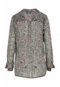 Blouse longue en tissu transparent à manches longues avec des rayures zébrées noires et blanches et des imprimés de lèvres rouges, dotée d'un col et de poignets plissés.