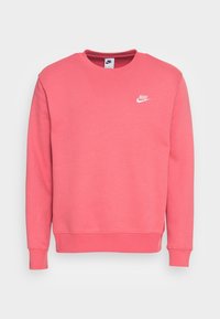 Rosa Nike-tröja med långa ärmar, rund hals, ribbade ärmslut och nederkant, med en liten vit logotyp på övre vänstra bröstområdet.