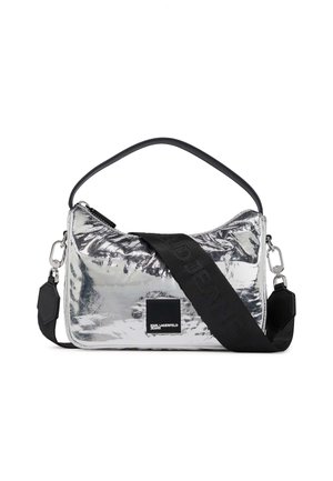 Shiny silver rectangular handbag with black handle and wide black adjustable strap, featuring a small front logo patch.