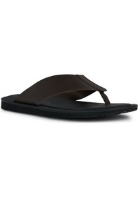 Chanclas negras con una suela de goma suave. Las tiras están hechas de un material oscuro y suave con un diseño minimalista y una separación para el dedo del pie.