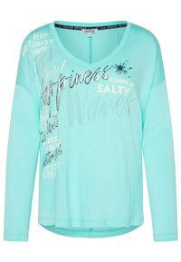 Turfärgad långärmad topp med V-ringning, med silvertryckt text och dekorationer. Mjuk, lätt tyg, avslappnad passform och rundad fåll.