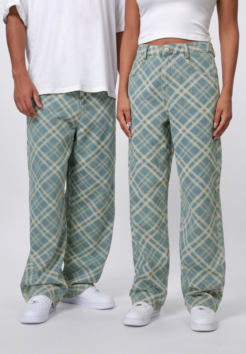 Blue plaid wide-leg pants featuring a light beige grid pattern, made from denim, paired with white sneakers.