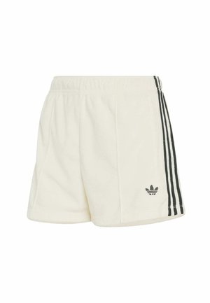 Białe szorty polarowe z czarnymi bocznymi paskami. Elastyczny pas, miękka tekstura i małe czarne logo na dolnej lewej nodze.