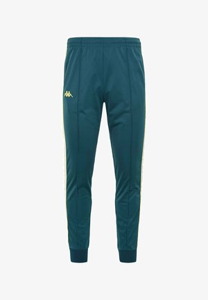 Pantaloni da jogging teal realizzati in tessuto morbido, con strisce laterali gialle e un piccolo logo sulla coscia sinistra. Vita elasticizzata e polsini.