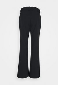 Pantalon noir évasé vu de dos avec passants pour ceinture et légers détails de couture sur un fond clair uni.