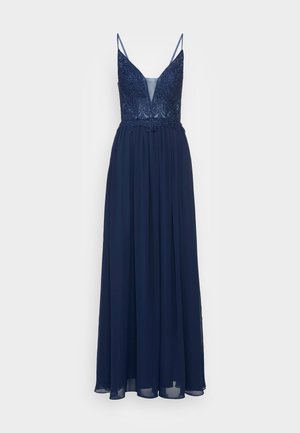 Navy blue evening dress with a deep V-neck, embellished bodice, and flowing chiffon skirt. Features thin adjustable spaghetti straps.