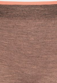 Brown knitted fabric with a textured surface. Features a solid light orange waistband. No additional patterns or embellishments present.