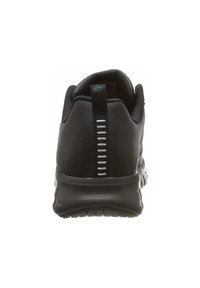 Baskets de sport noires avec une tige en cuir lisse, un col rembourré et une semelle en caoutchouc texturée avec un accent vertical au niveau du talon.