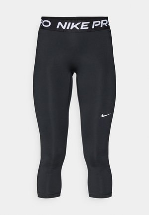 Sorte Nike Pro leggings med en bred linning, der har "NIKE PRO" i hvidt. Materialet er glat og strækbart, designet til atletisk brug.