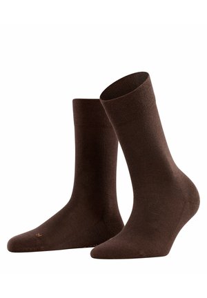 Chaussettes en coton marron avec texture côtelée, longueur mi-mollet et renfort à la pointe. Design lisse avec un minimum de détails de couture.